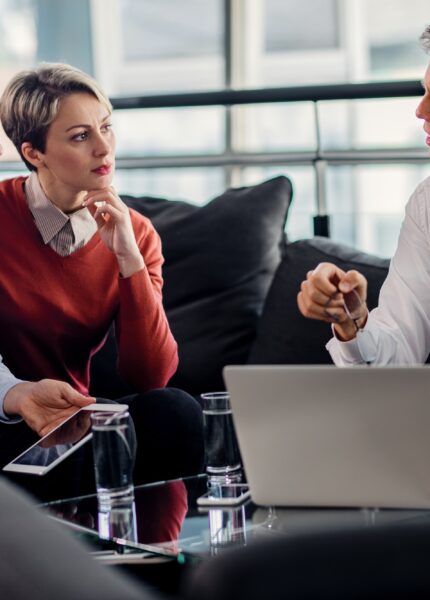 Insurance agent talking to mid adult couple on a meeting in the office.